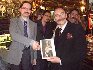 Helsinki University Moustache Club President, Alex presents Handlebar Club Scribe Tom Cutler with an archive photo of Baron Carl Gustaf Mannerheim - Click to enlarge